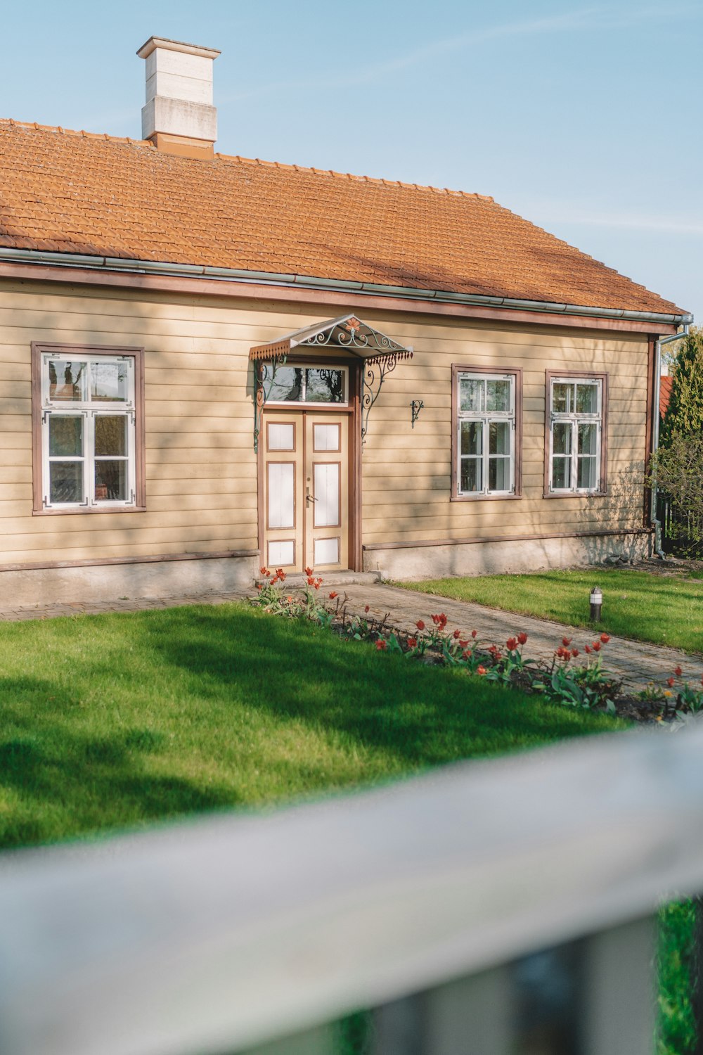 brown brick house with green grass lawn