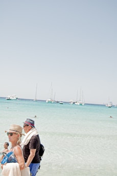 A bright, sunny day with children learning to sail on small boats in Didim's calm waters.