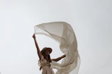 A vibrant outdoor scene featuring a flowing dress catching the breeze on a sunny day.