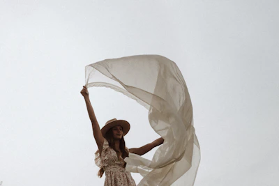 A vibrant outdoor scene featuring a flowing dress catching the breeze on a sunny day.