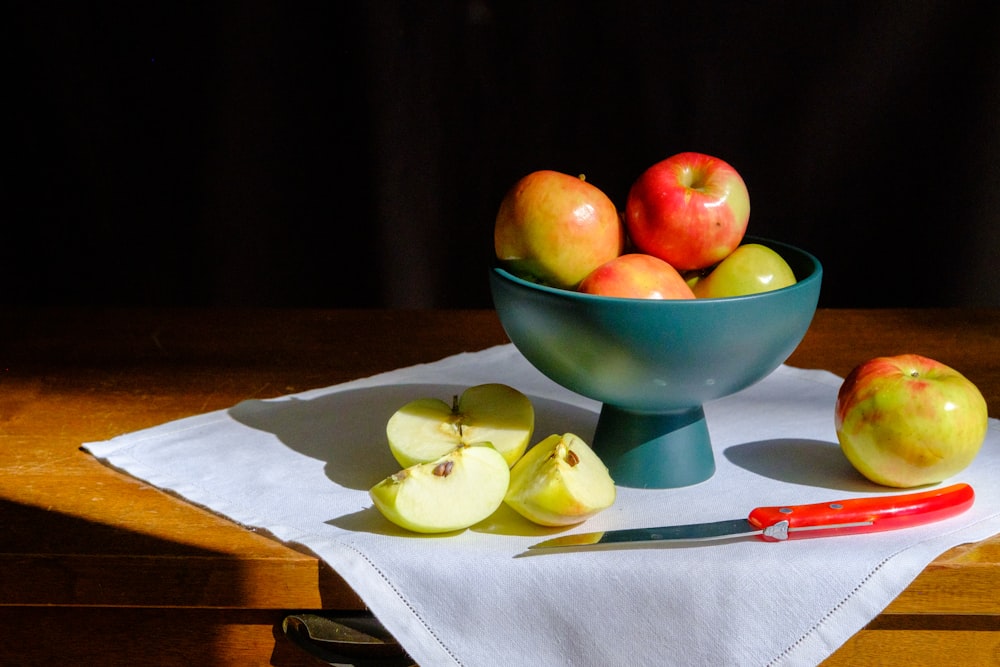 green apple fruit on green ceramic bowl