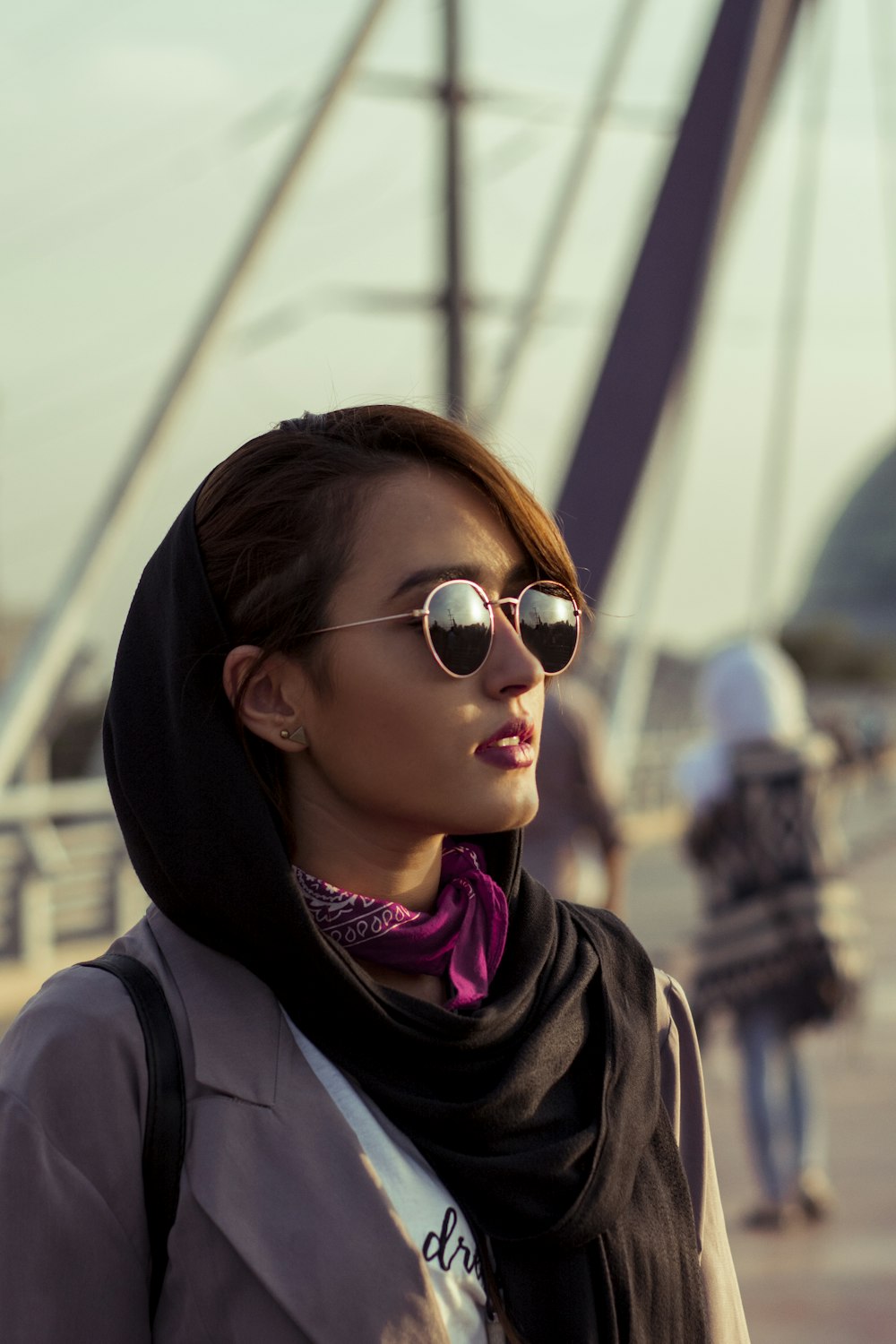 woman in black coat wearing brown sunglasses