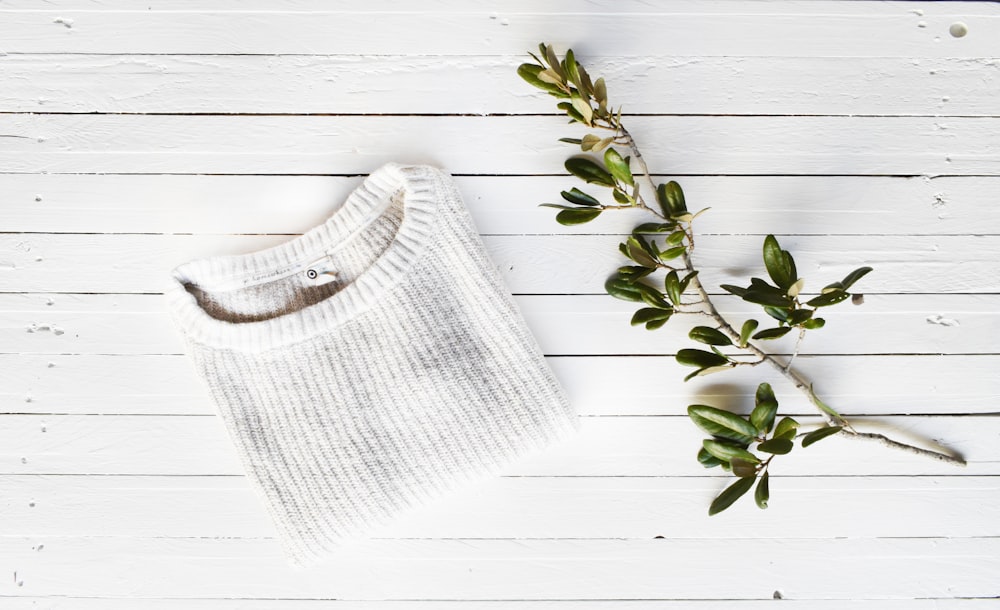 white knit sweater on white wooden surface