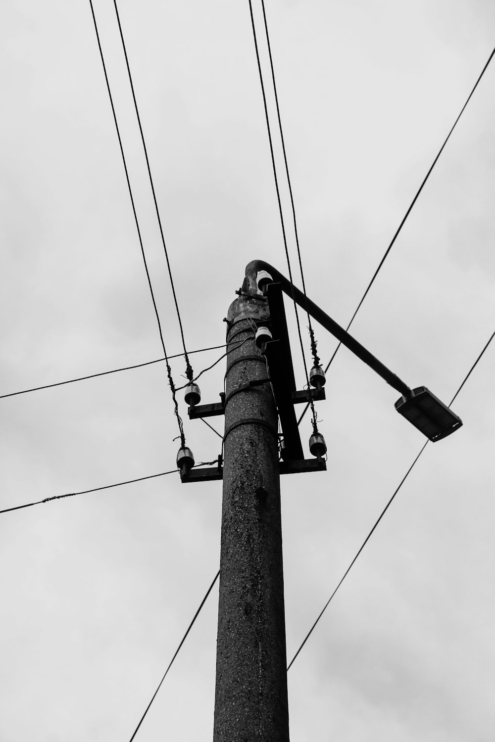 black electric post under cloudy sky