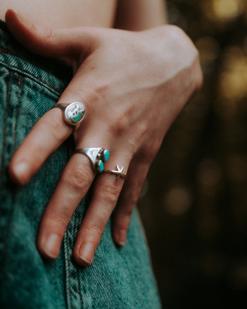 person wearing silver and blue gemstone ring