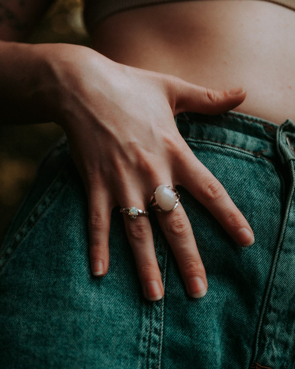 person wearing silver and gold rings