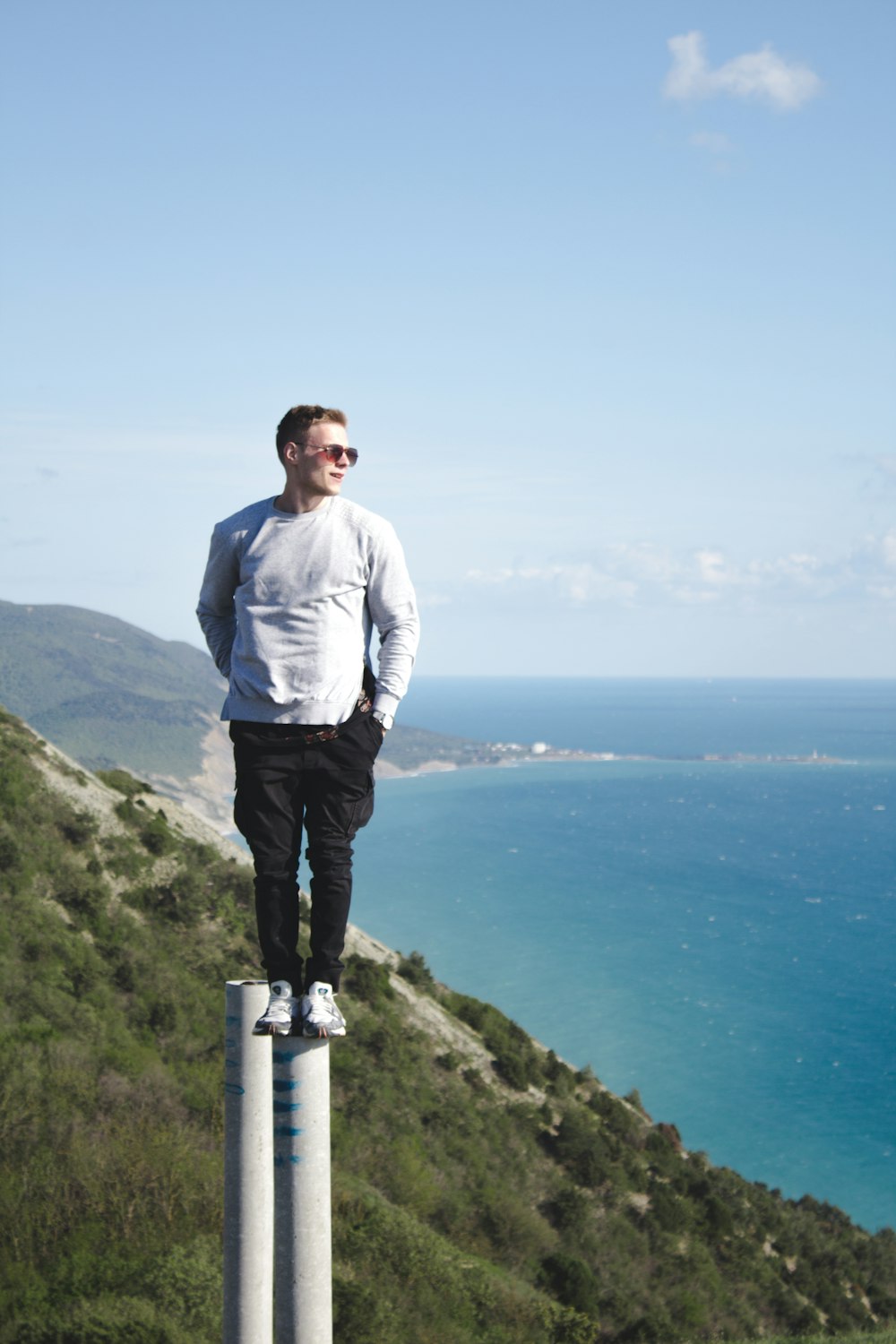 man in white dress shirt standing on top of mountain during daytime