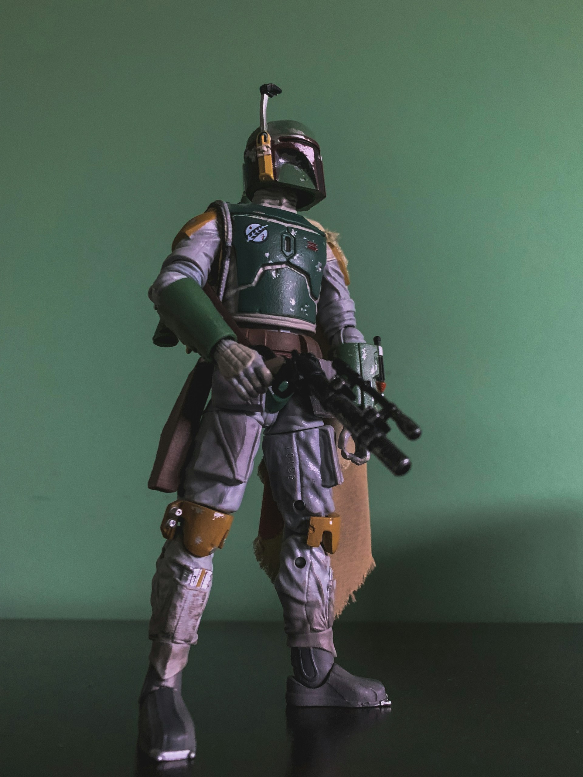 Vibrant image of Teela figure standing tall on a rocky terrain with detailed armor and weapon.