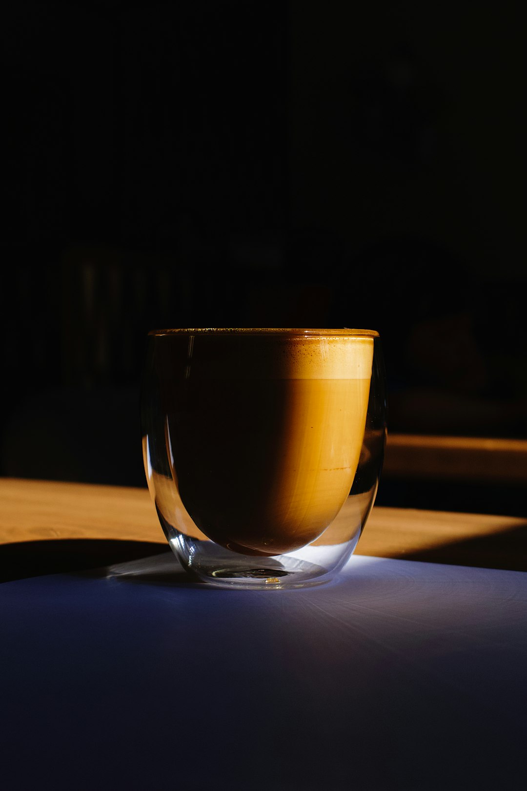 clear drinking glass with brown liquid