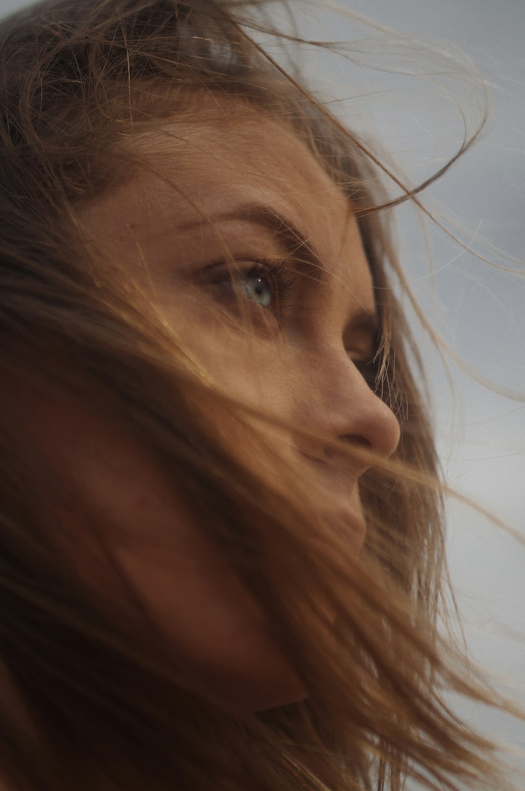 woman with brown hair looking down