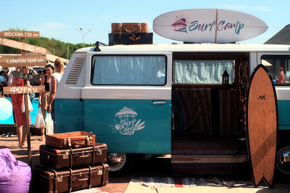 blue and white van with brown wooden crate