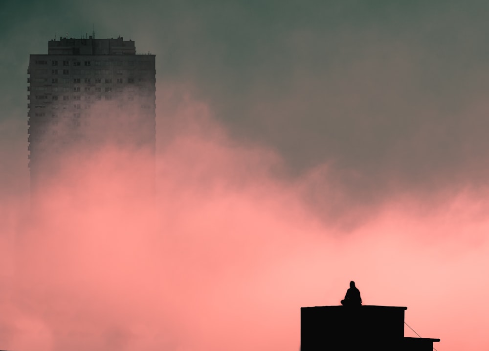 silhouette of building under cloudy sky