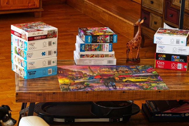 Stacked wooden puzzles with animal shapes on a bright table.