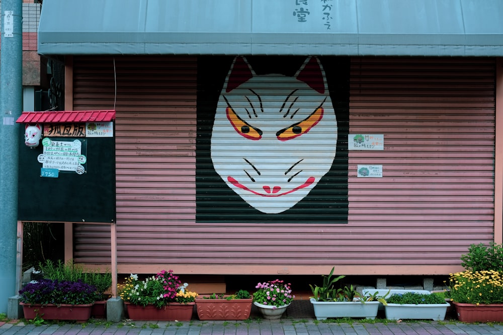 red and white wooden house with red flower and bird wall art