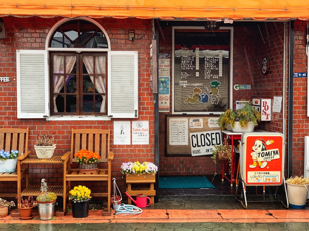 red and white wooden store with flowers and plants