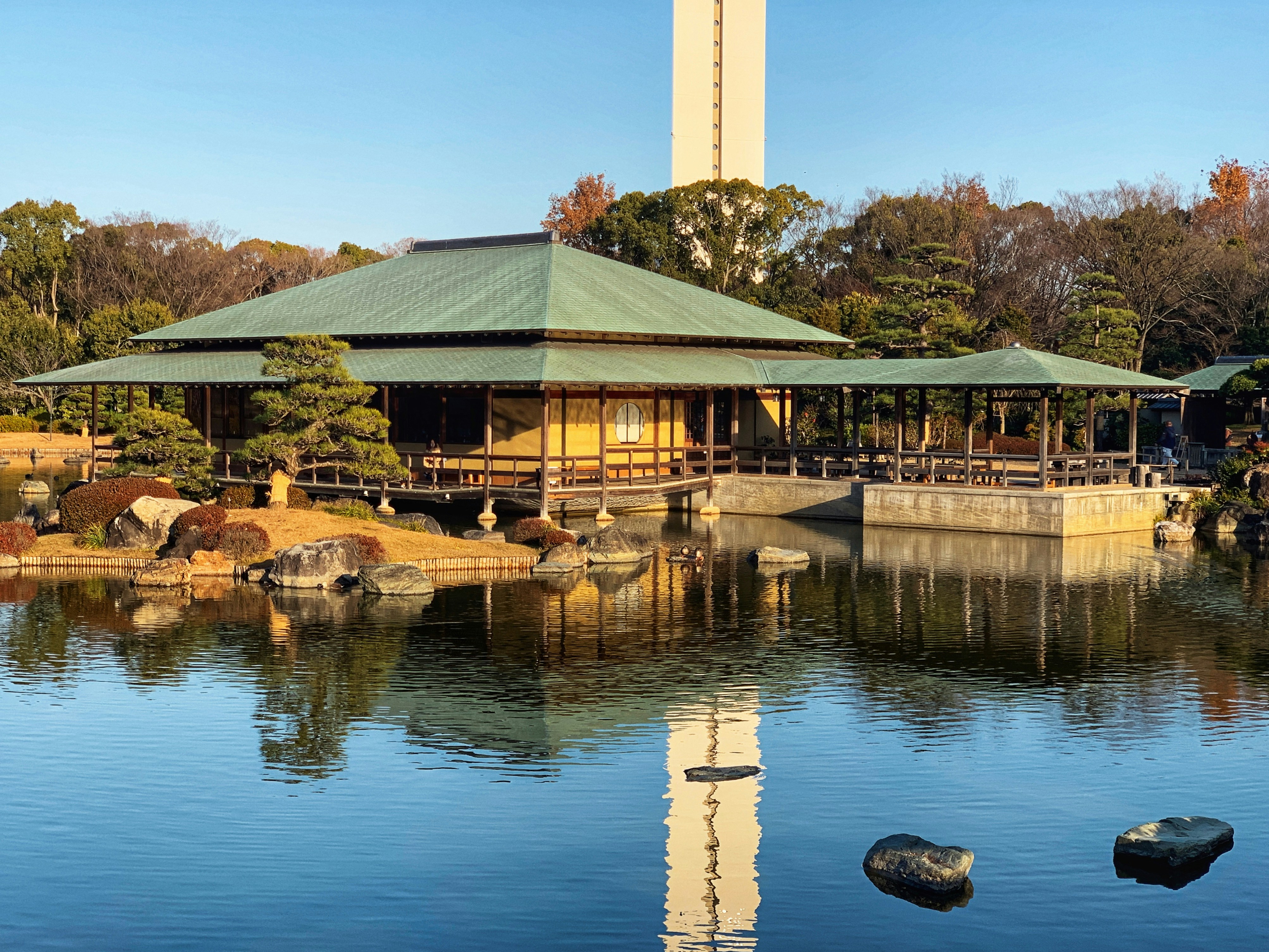 brown and white wooden house near body of water during daytime