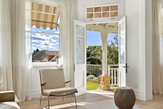 A bright room opens to a beautiful backyard.