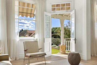 A bright room opens to a beautiful backyard.