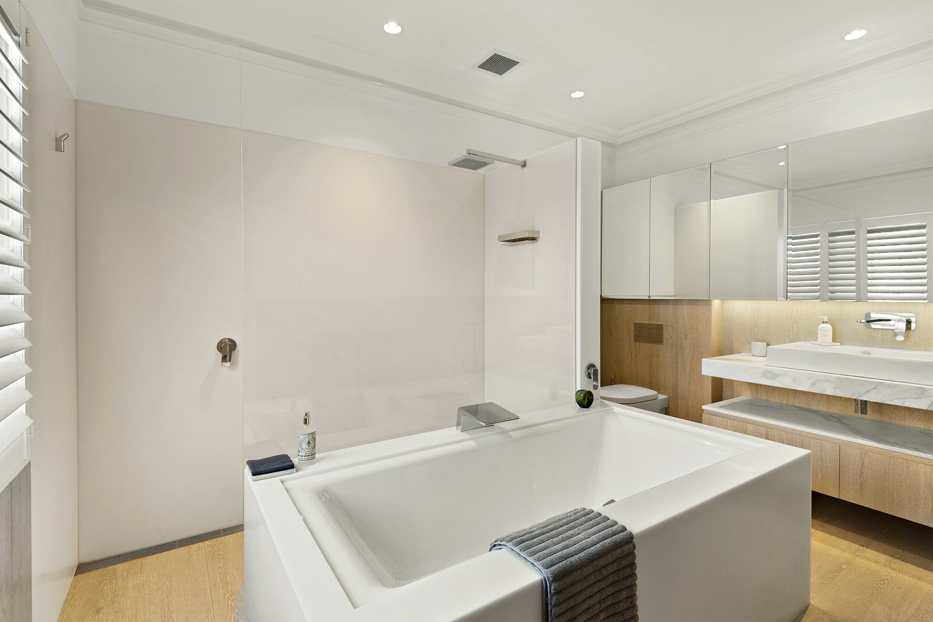 A modern bathroom with bathtub and shower.