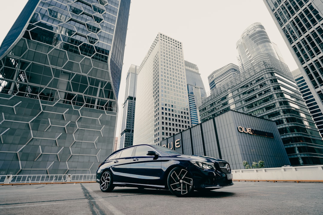 black porsche 911 parked on road near high rise buildings during daytime