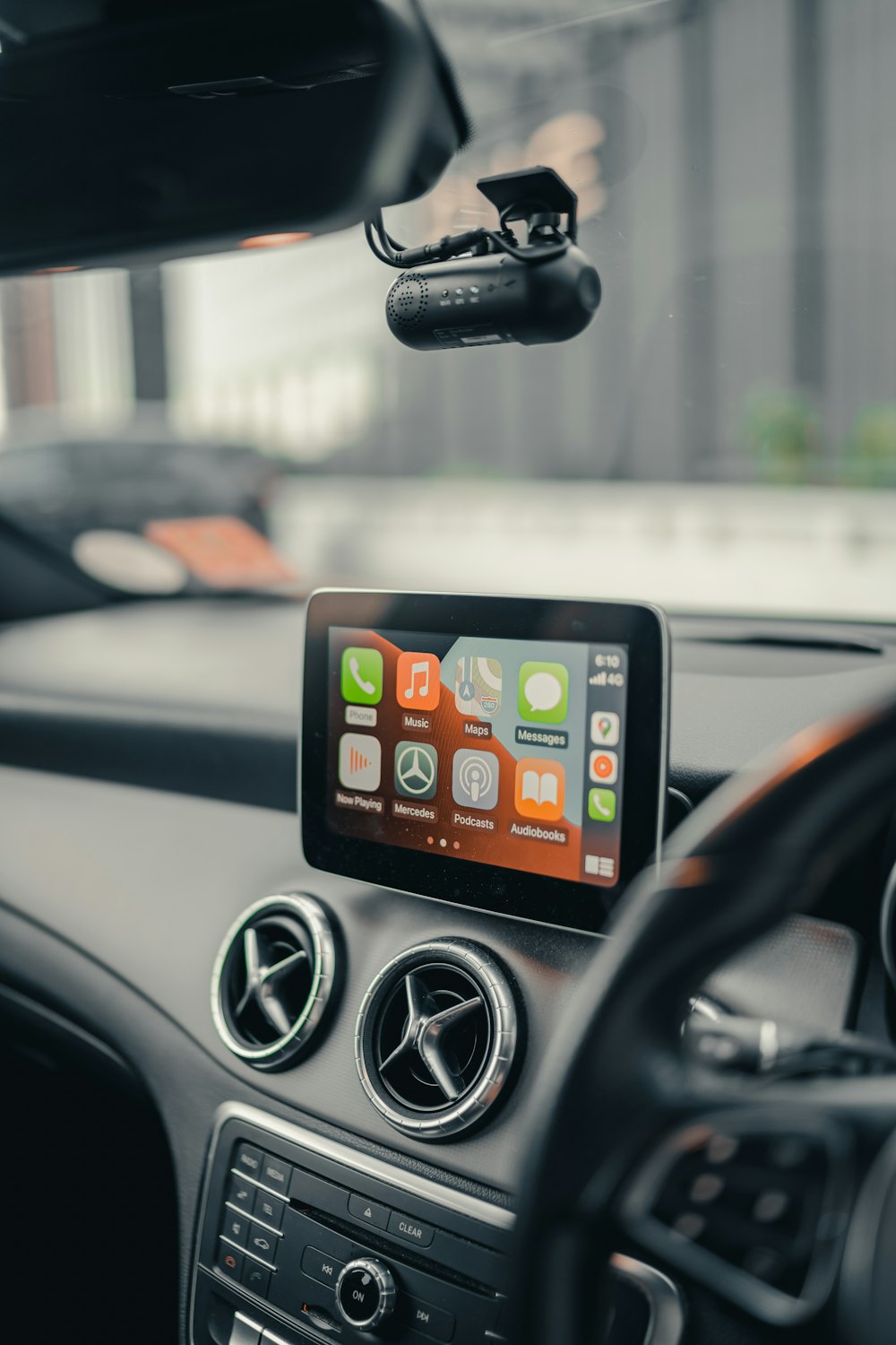 black iphone 4 on car dashboard