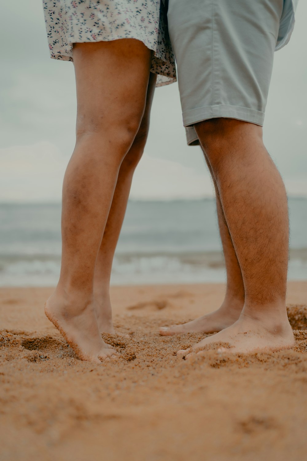 person in white shorts standing on beach during daytime