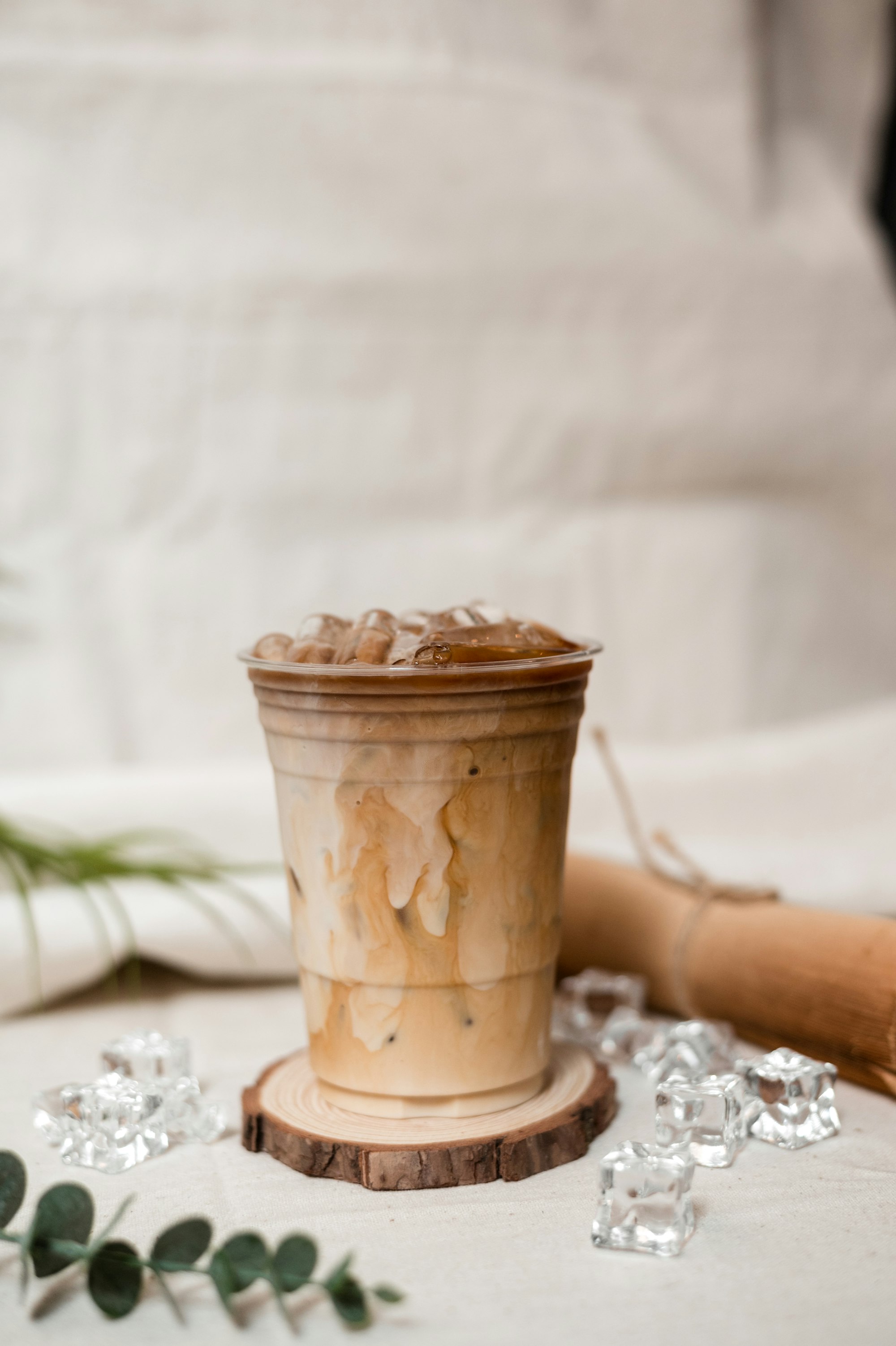 ice latte coffee in plastic glass on black table at cafe​