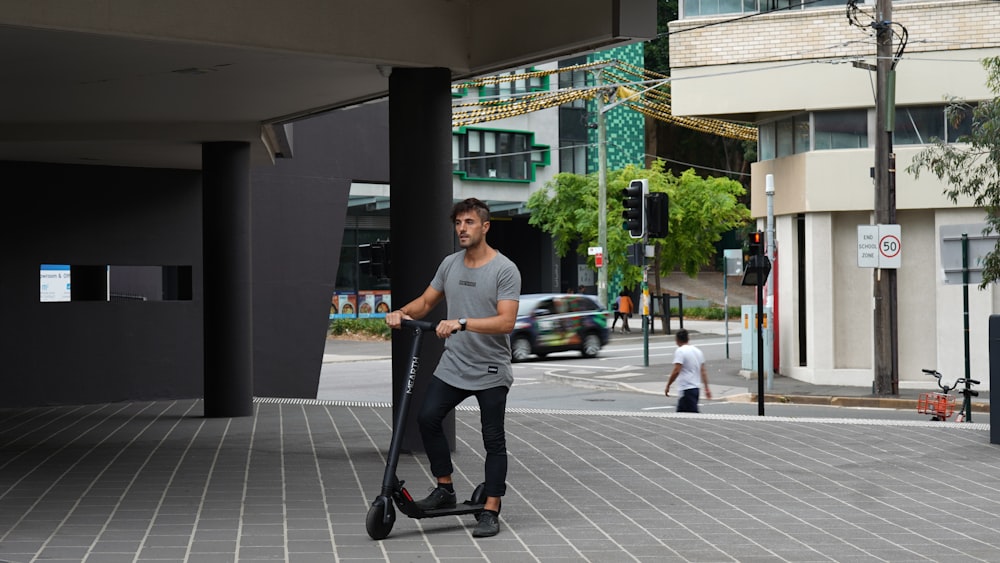 man in white crew neck t-shirt and black pants holding black luggage bag walking on near near near near
