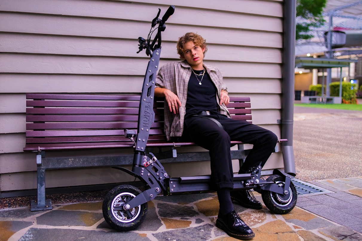 man in black jacket sitting on black and purple wheelchair