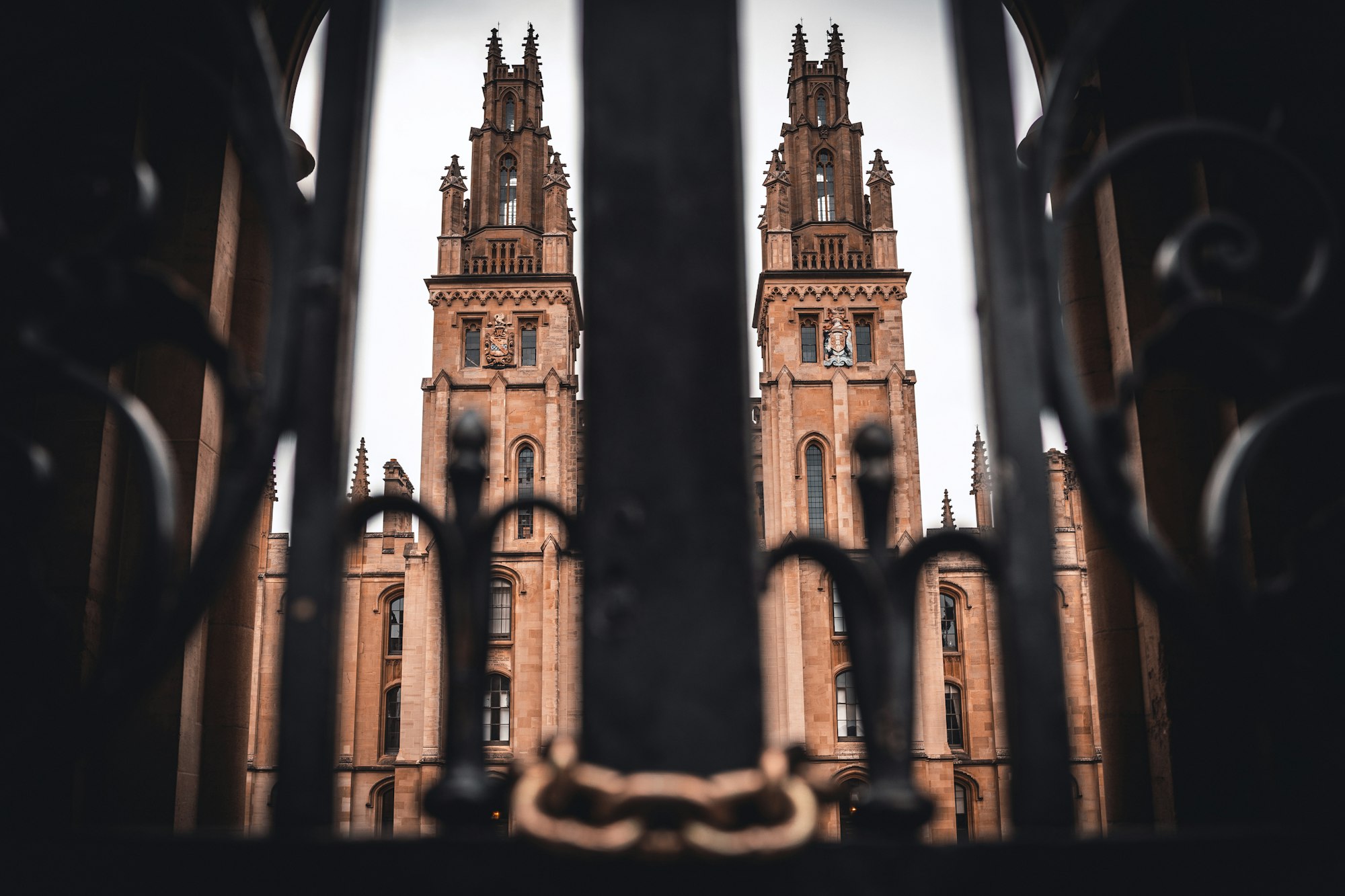 imposing oxford university towers viewed through a fence