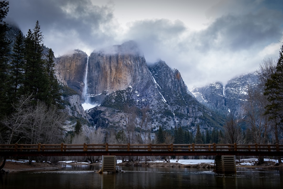 brown wooden bridge across rocky mountain during daytime