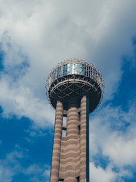 white and brown tower under blue sky and white clouds during daytime