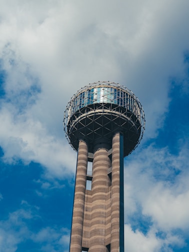 white and brown tower under blue sky and white clouds during daytime