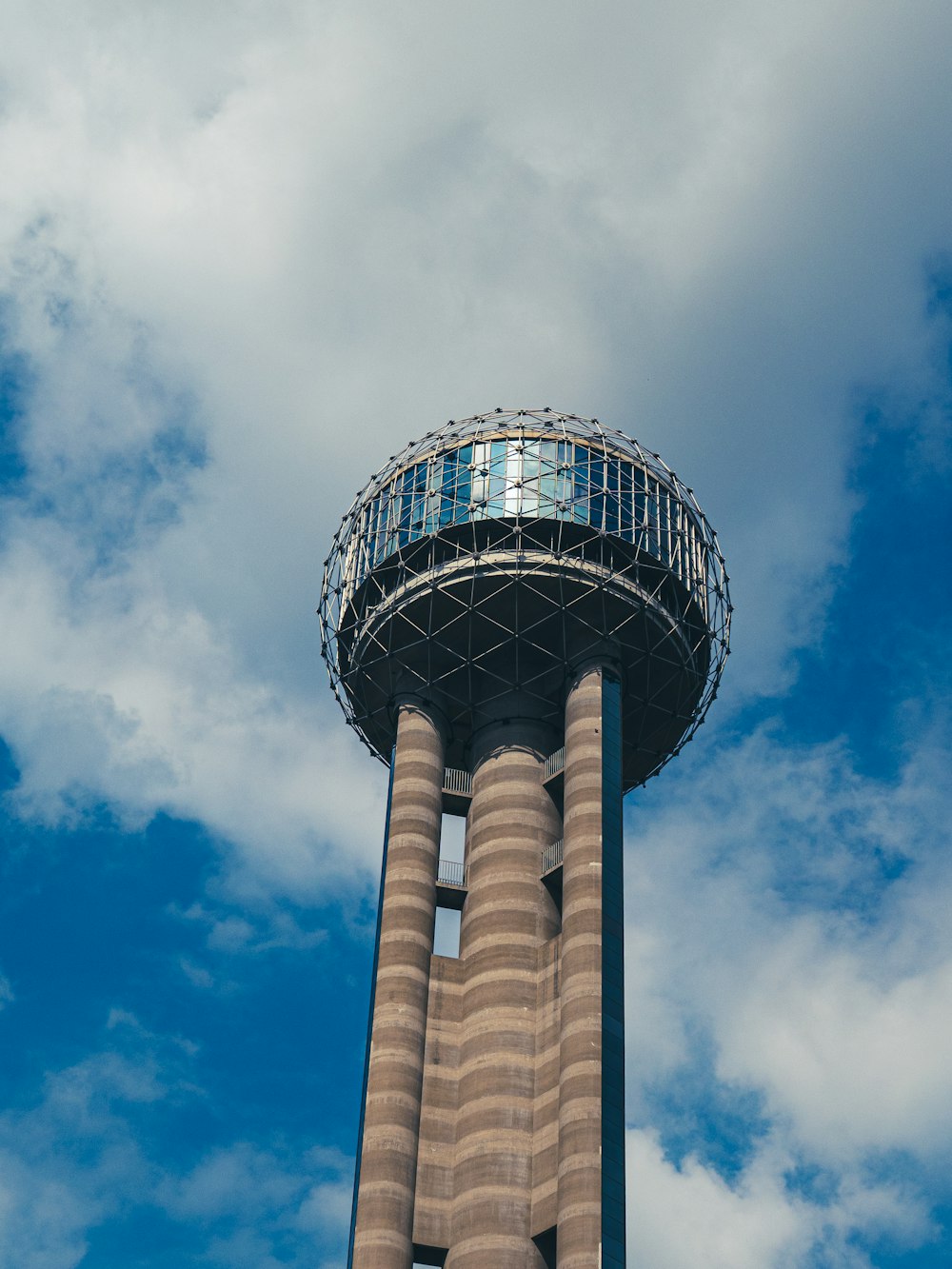 white and brown tower under blue sky and white clouds during daytime