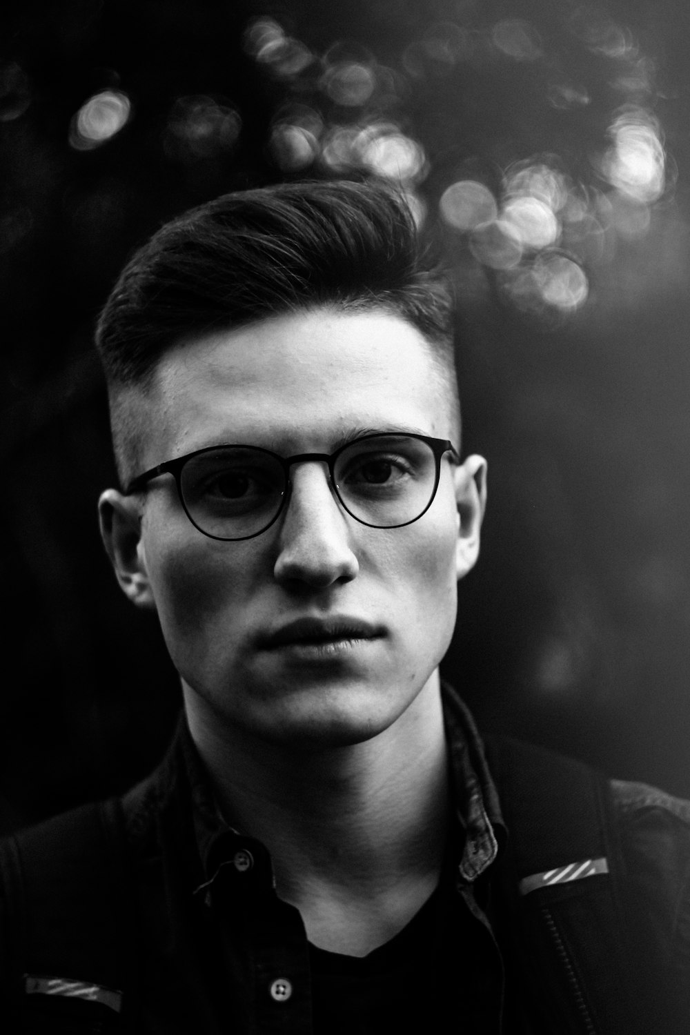 grayscale photo of man wearing eyeglasses