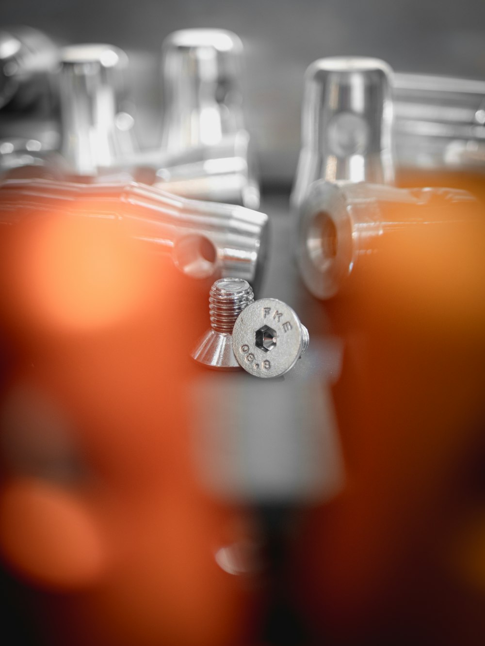 silver round coin on orange surface