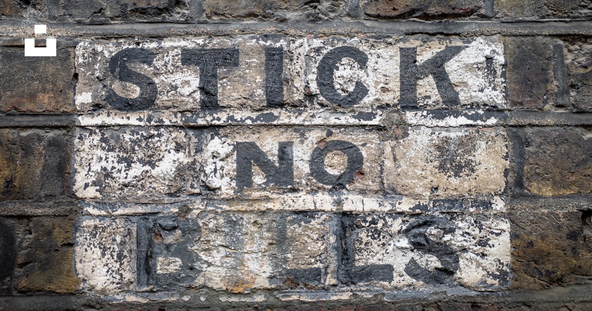A brick wall with a sign that says stick no rules photo – Free Grey ...