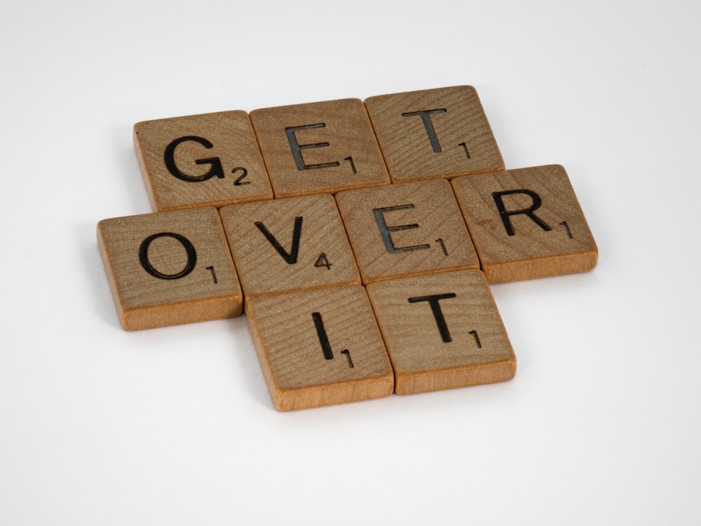 brown wooden letter blocks on white surface