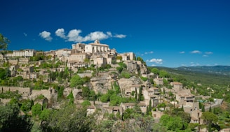 brown concrete building on top of mountain during daytime