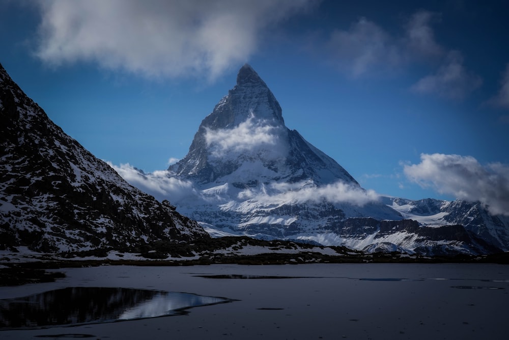 snow covered mountain under blue sky during daytime