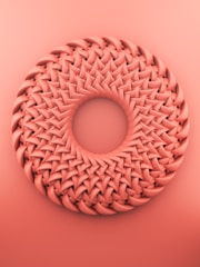 brown round ornament on pink surface