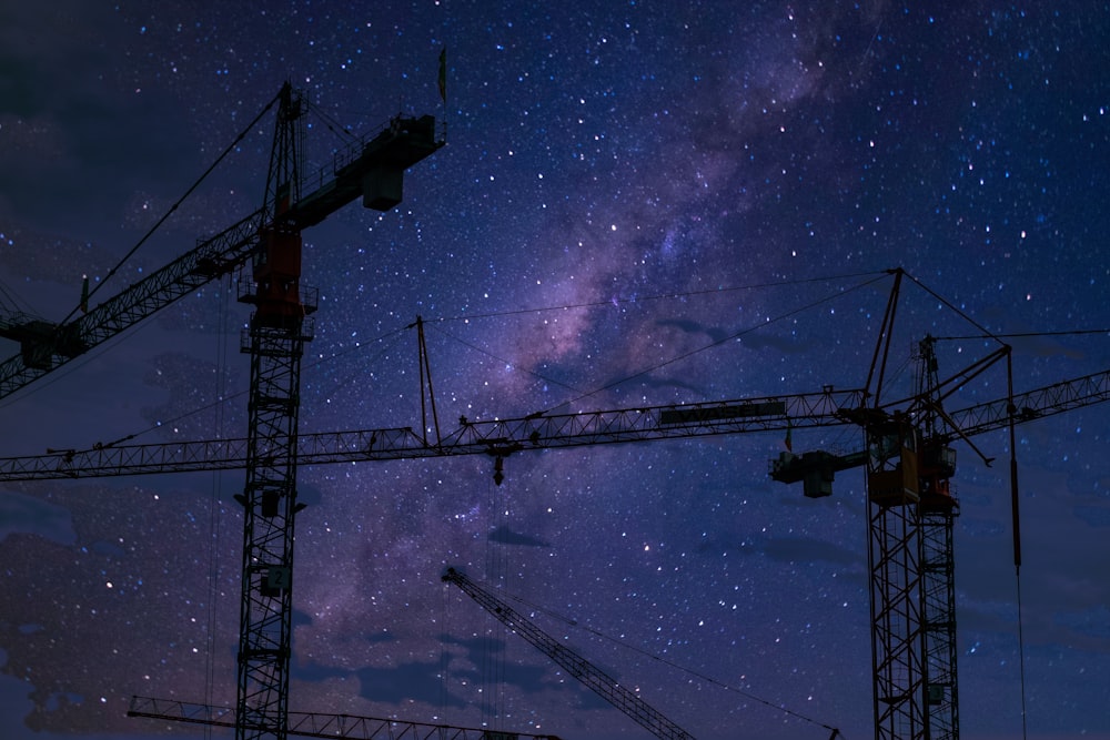 silhouette of crane under blue sky