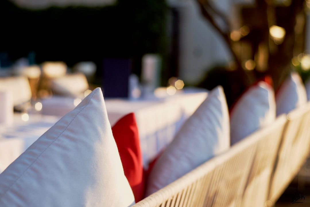 white pillow on red and white couch