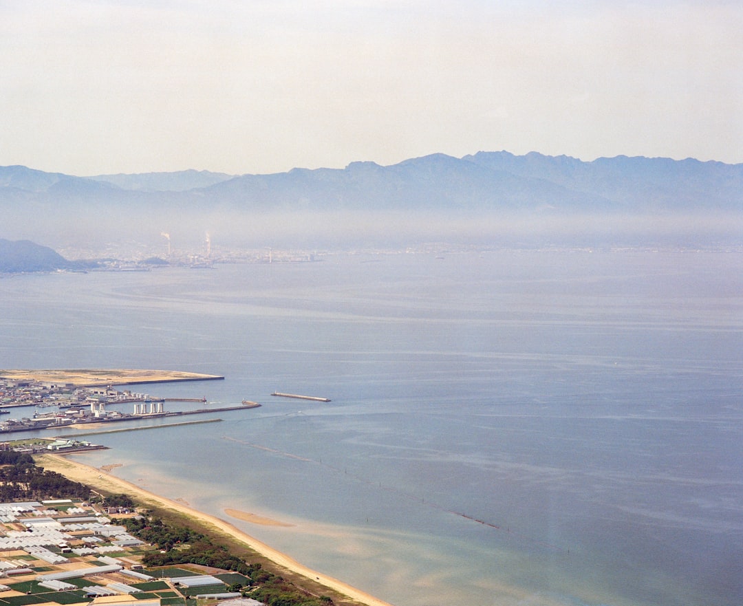 body of water near mountain during daytime