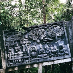 A detailed sculpture of Shiva meditating in a forest