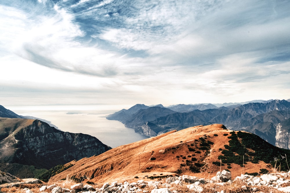 brown and green mountains under white clouds during daytime