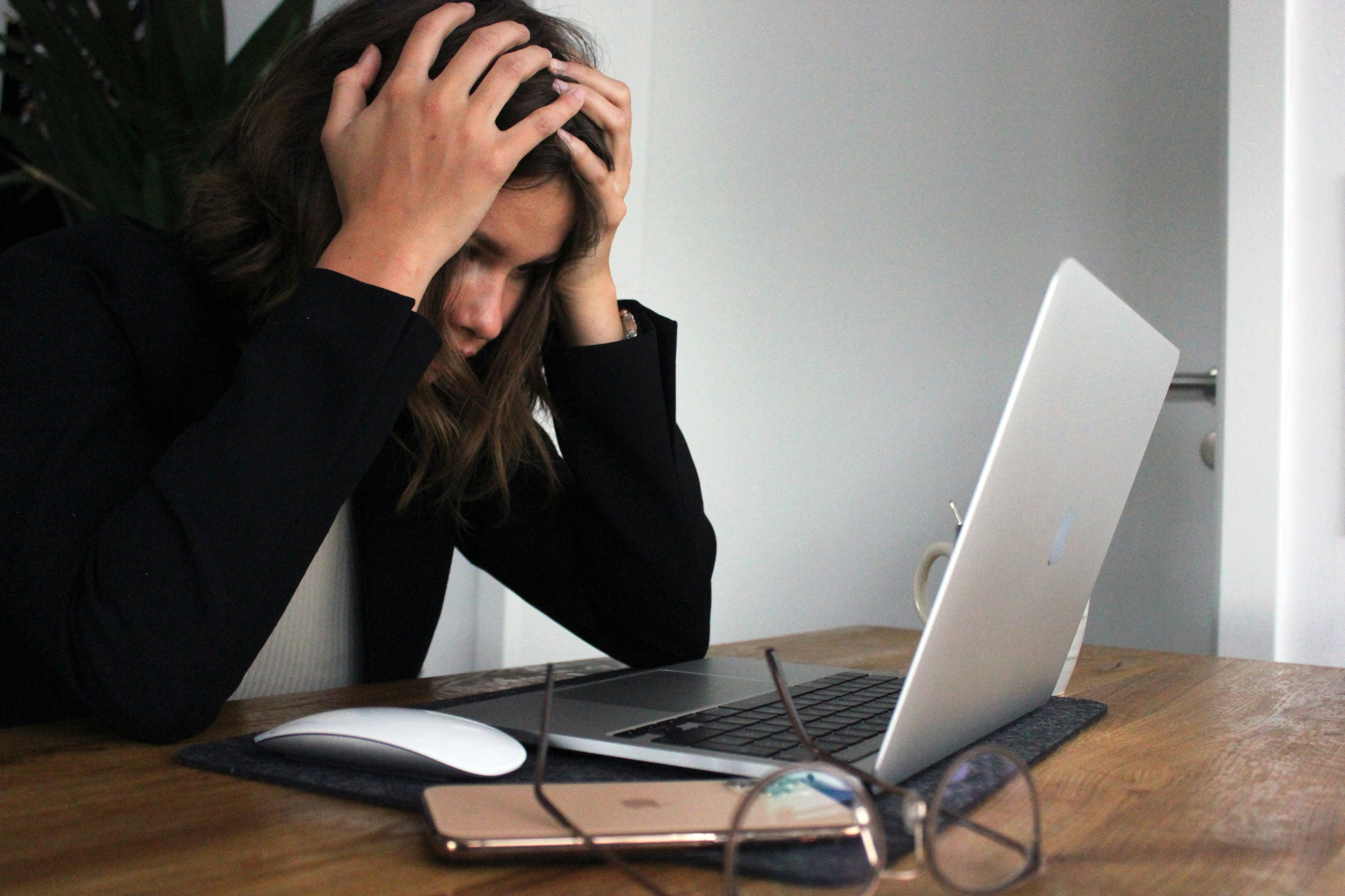 Woman looking at laptop frustrated