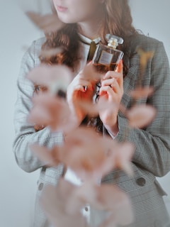 A lifestyle shot of a person applying lee stone perfume before heading out, capturing a moment of confidence and freshness.
