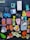 A collection of colorful, artistic stickers are arranged on a dark background. The stickers feature a variety of designs including a cat, teeth, a carton labeled 'Toof Tac', artistic portraits, a heart with the text 'Tooth Ache', and a large moth. There is a mix of cartoonish and realistic elements, with some stickers displaying text and images of hands showing peace signs.