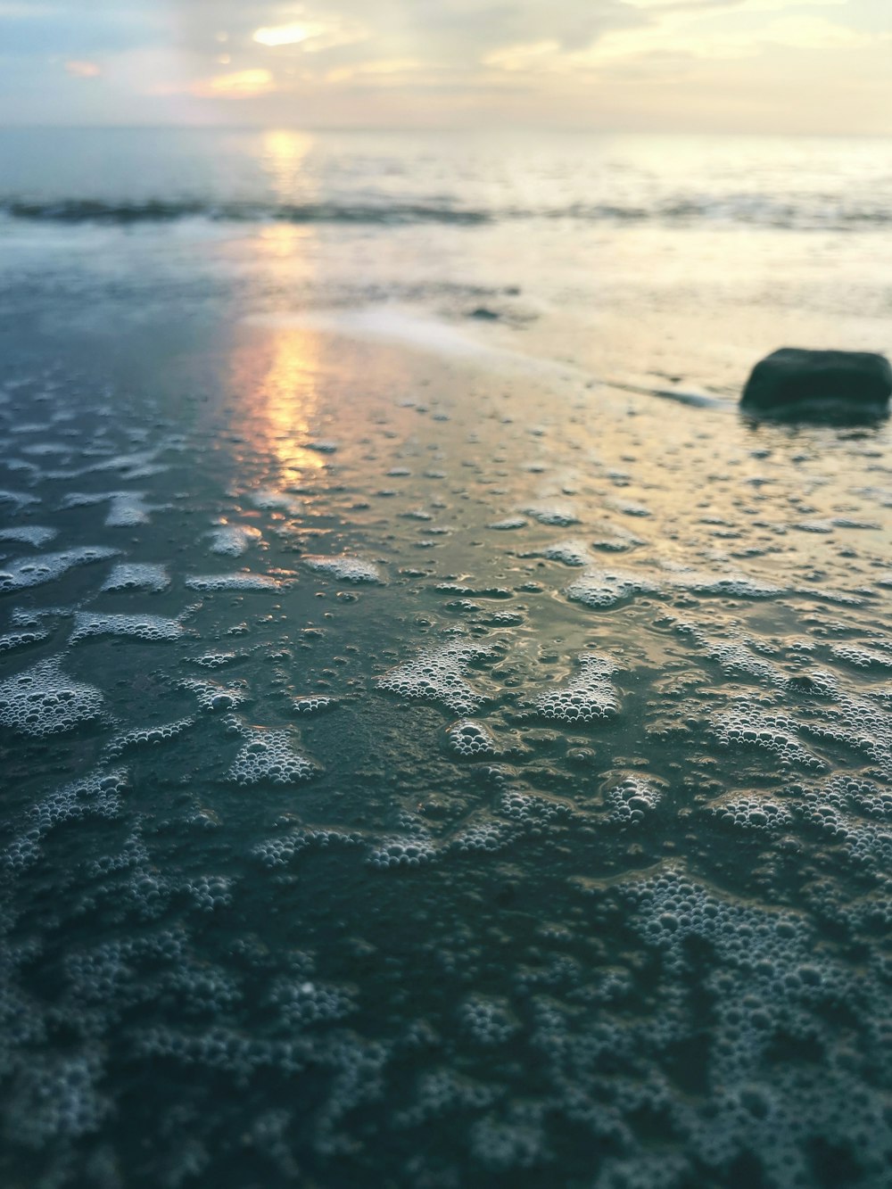 water waves on shore during sunset